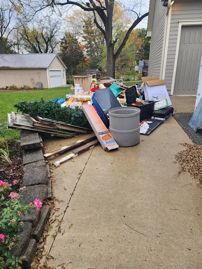 Dumpster being loaded with debris for Roofing Dumpster Rental in Bartow